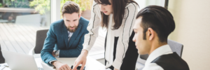 young-businesswoman-and-men-pointing-at-laptop-whi-2024-10-21-09-20-22-utc